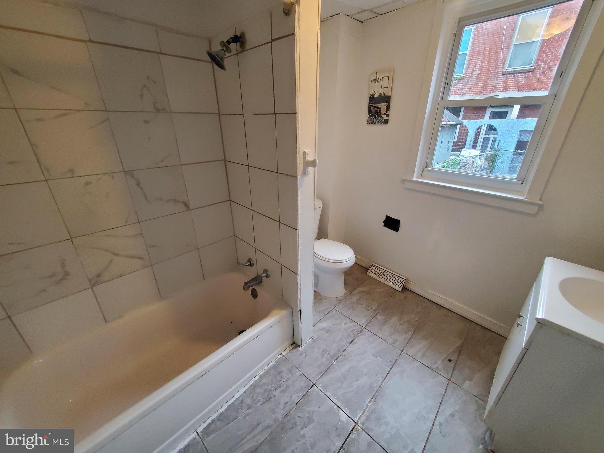 404 South 9th Street Reading, PA 19602 - Photo 5 of 11 a bathroom with a bathtub and a toilet