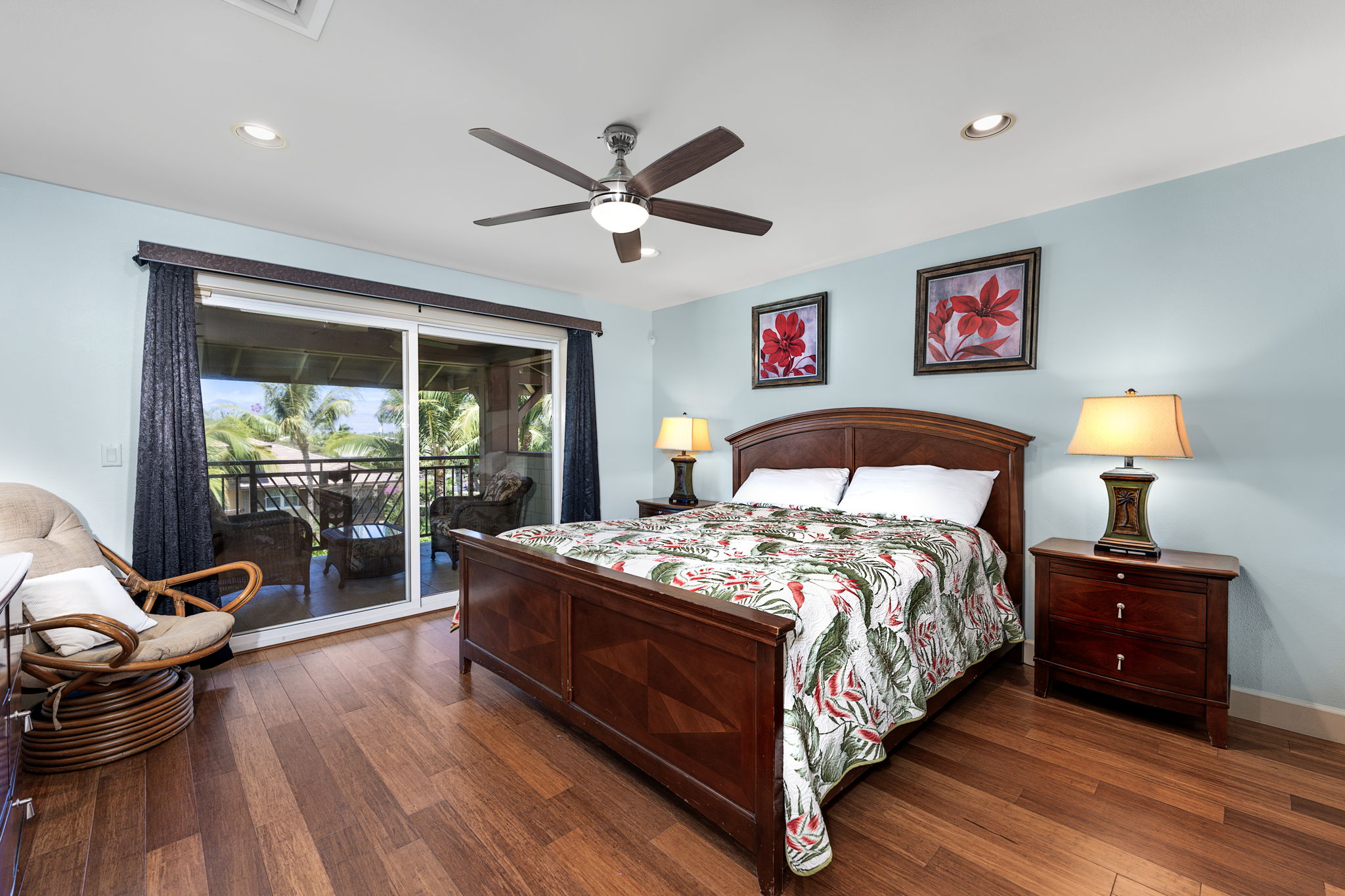 69-1033 Nawahine Place, Unit 22G Waikoloa, HI 96738 - Photo 13 of 30 a bedroom with a bed and wooden floor