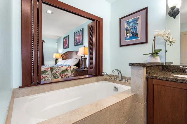 a bathroom with a granite countertop sink and a mirror
