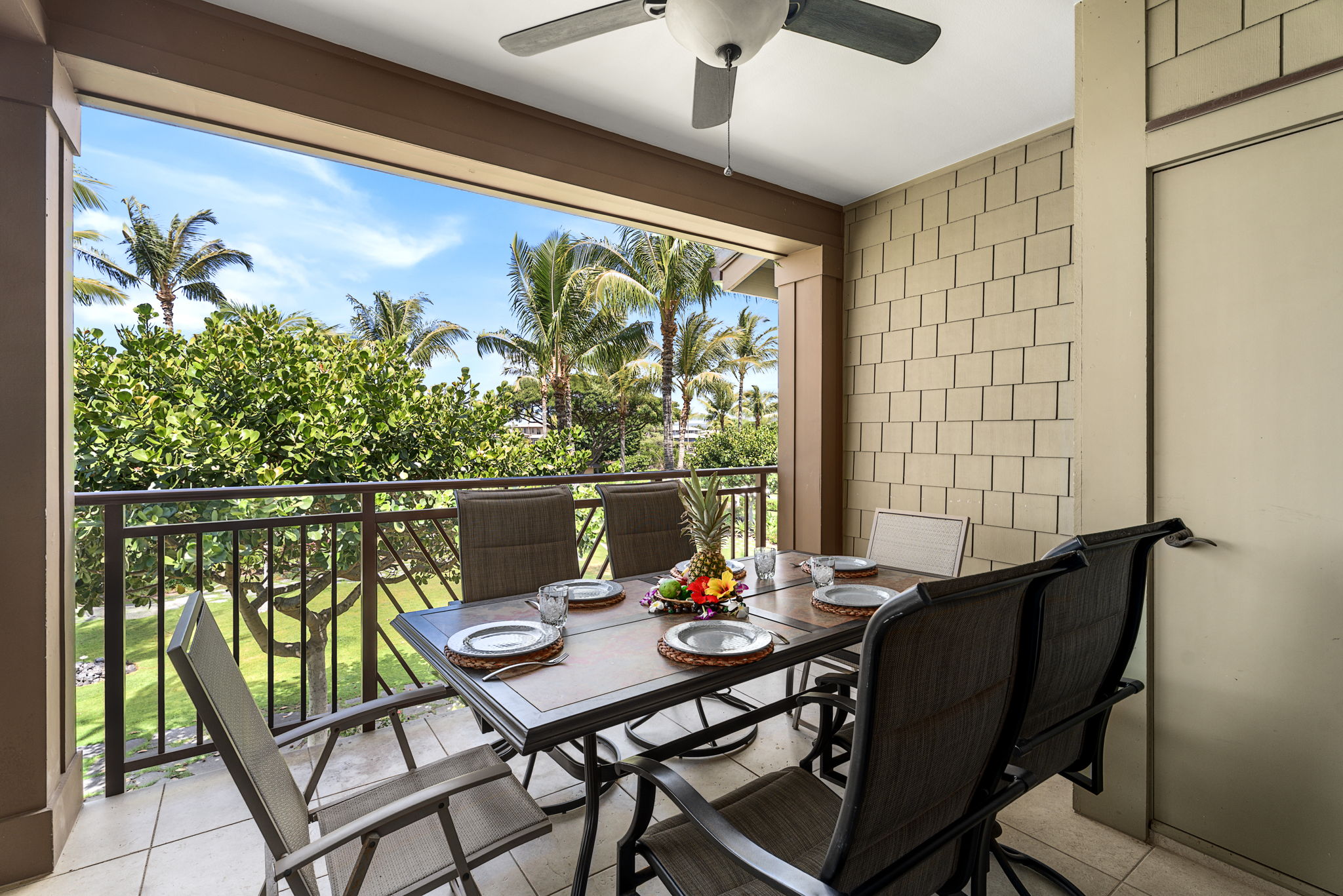 69-1033 Nawahine Place, Unit 22G Waikoloa, HI 96738 - Photo 2 of 30 a view of a balcony dining table and chairs with wooden floor