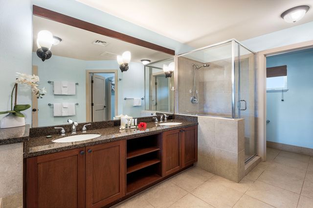 a bathroom with a double vanity sink mirror and double