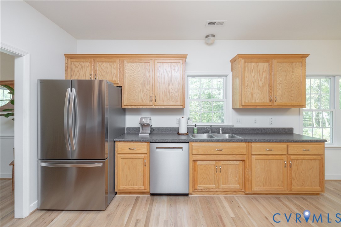 15618 Rowlett Road Chesterfield, VA 23838 - Photo 4 of 29 a kitchen with stainless steel appliances granite countertop a refrigerator sink and cabinets