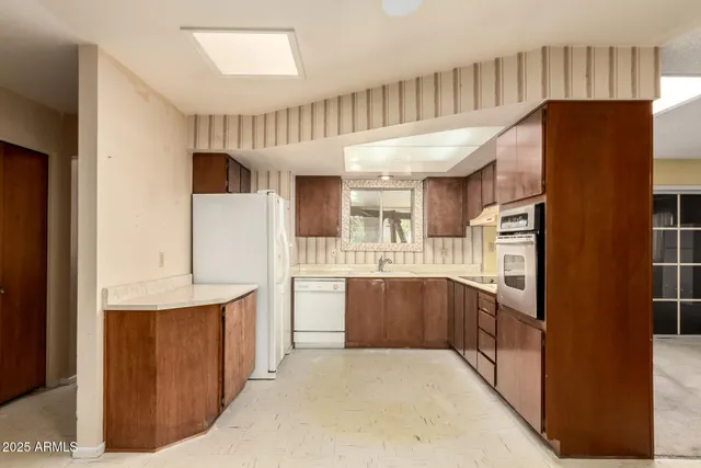 a kitchen with stainless steel appliances a refrigerator and a stove top oven
