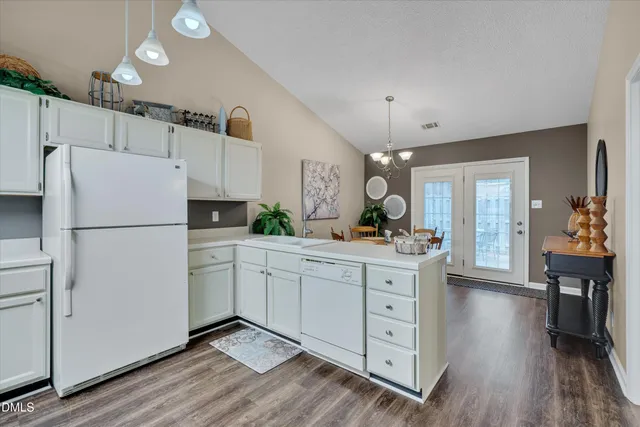 a kitchen with white cabinets and white appliances