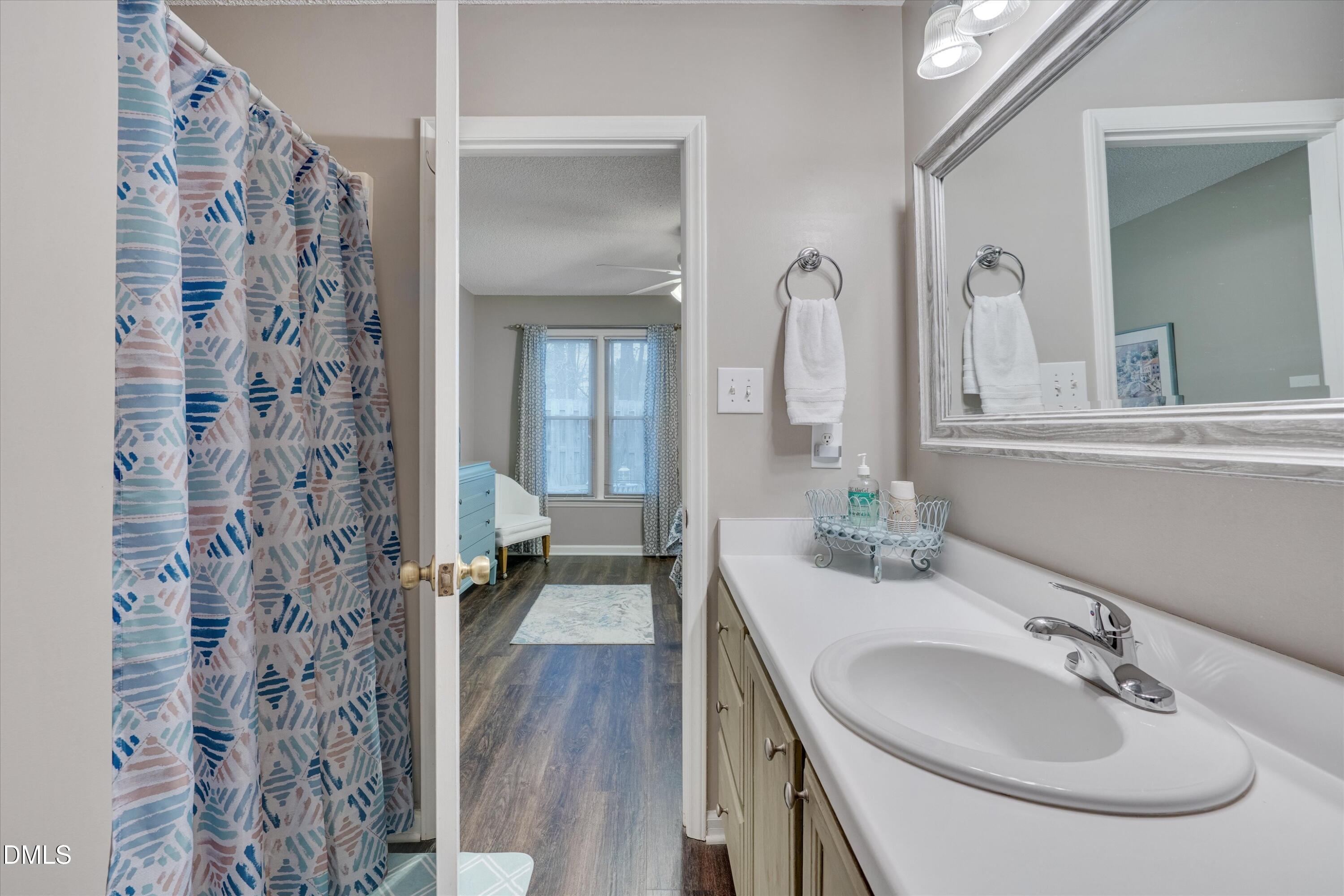 120 Sparger Springs Lane Durham, NC 27705 - Photo 18 of 26 a bathroom with a sink and a mirror