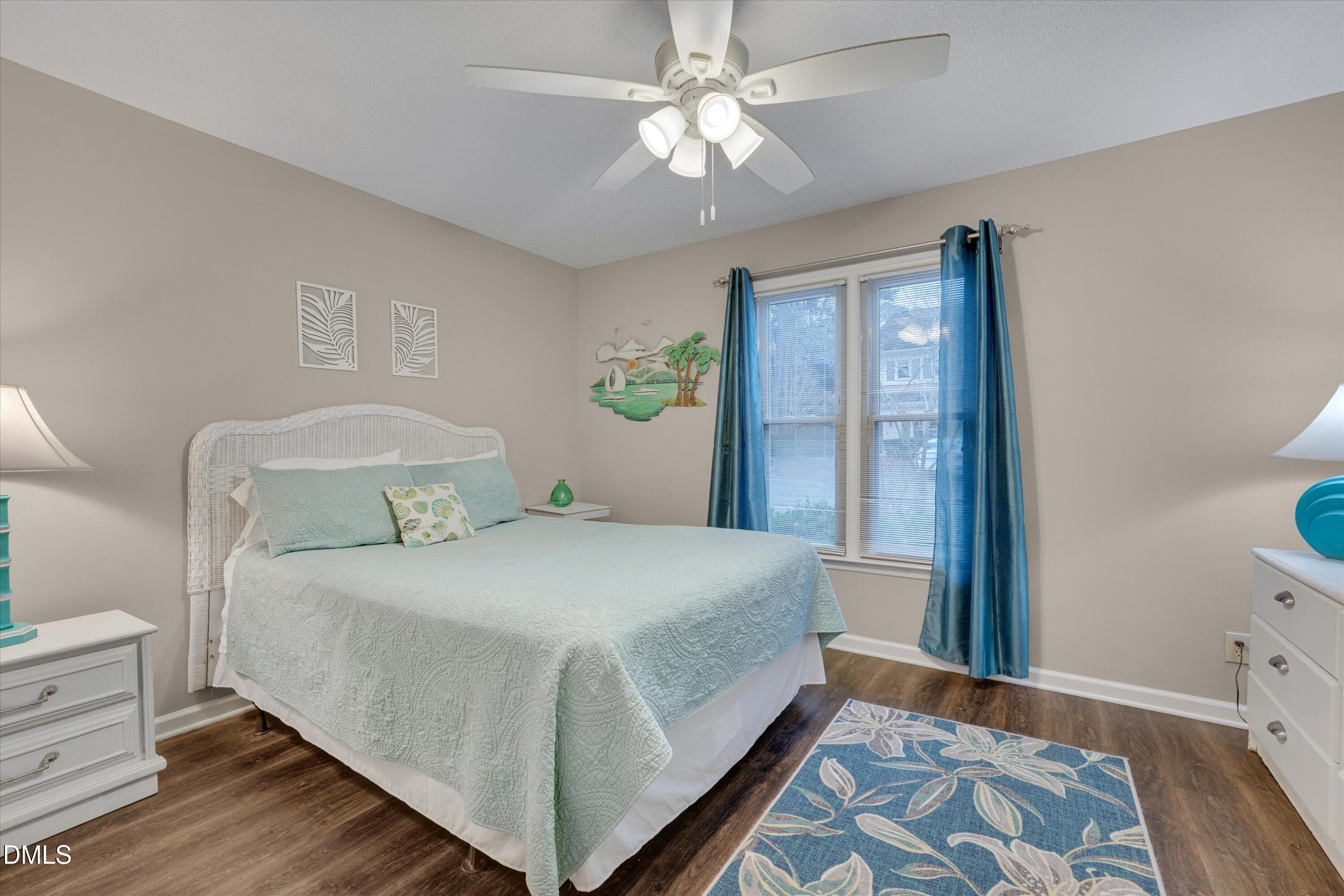 120 Sparger Springs Lane Durham, NC 27705 - Photo 20 of 26 a bedroom with a bed and a chandelier