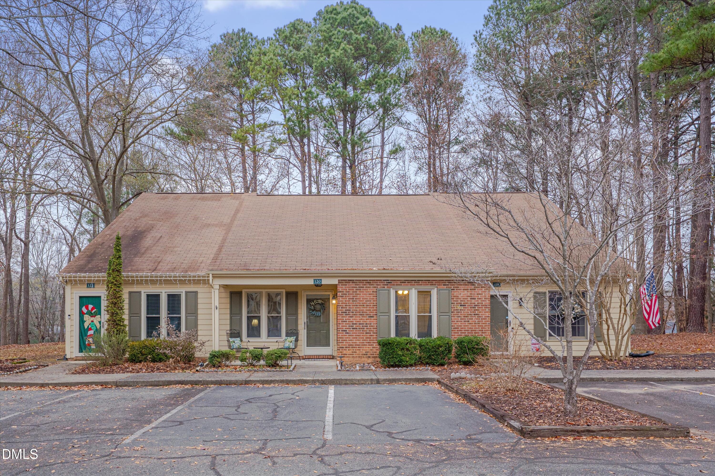 120 Sparger Springs Lane Durham, NC 27705 - Photo 2 of 26 a view of a building with a garden and pathway