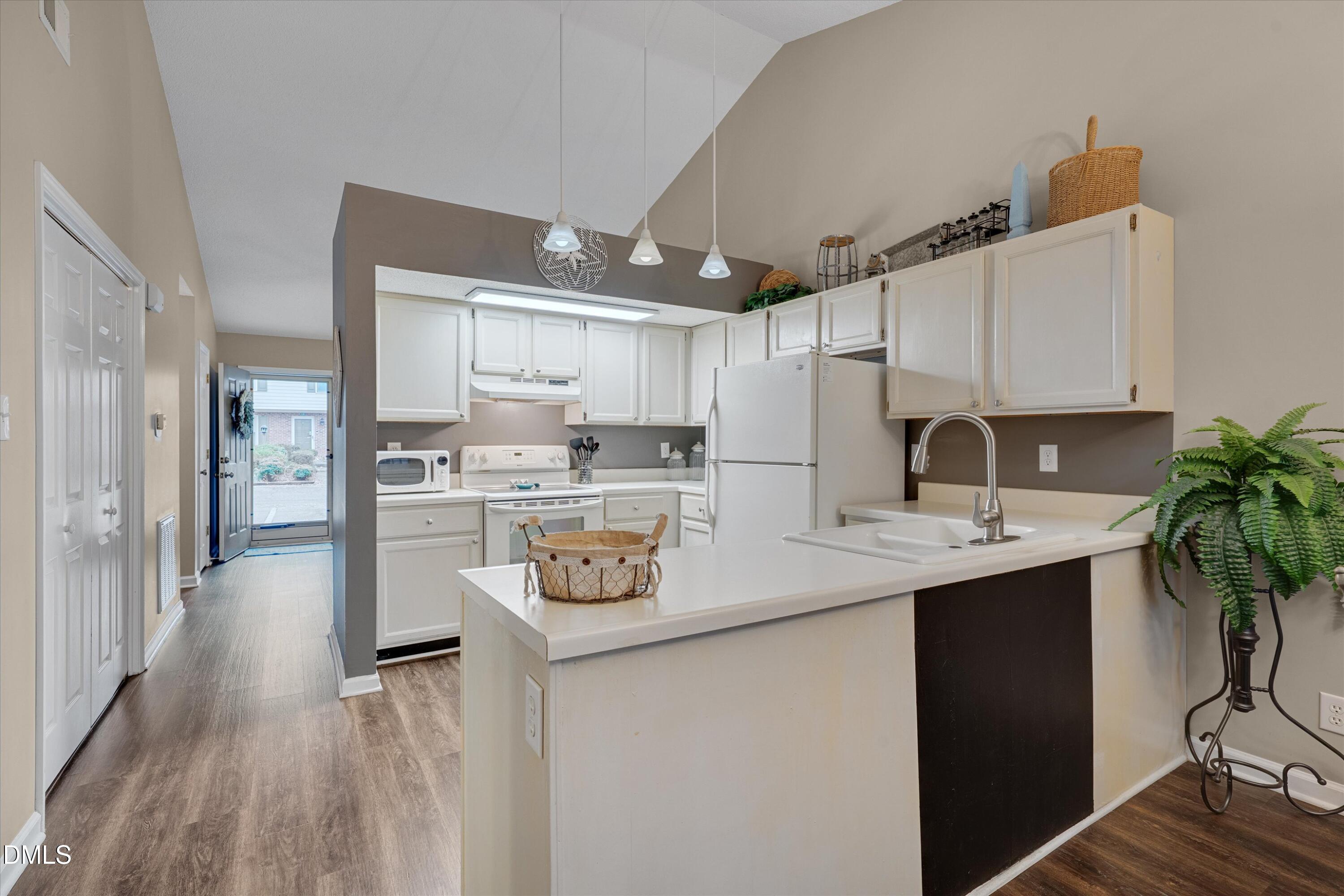 120 Sparger Springs Lane Durham, NC 27705 - Photo 9 of 26 a kitchen with a sink a refrigerator and cabinets