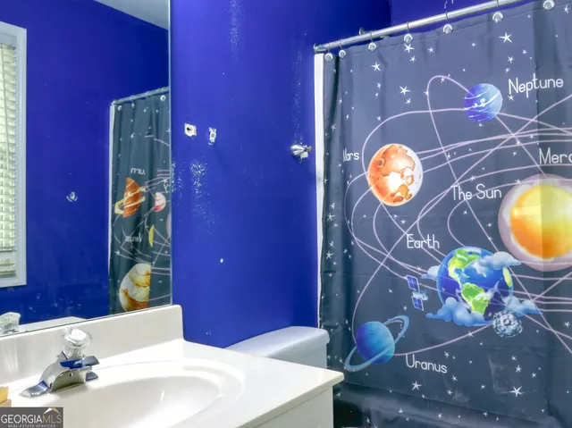 a bathroom with a sink mirror and vanity