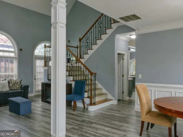 a view of entryway and hall with wooden floor