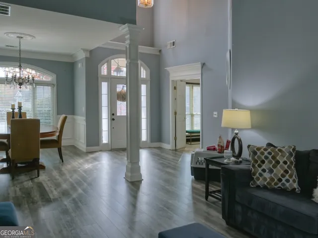 a living room with furniture and a lamp