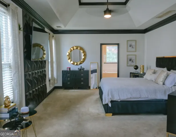 a spacious bedroom with a bed window and a mirror
