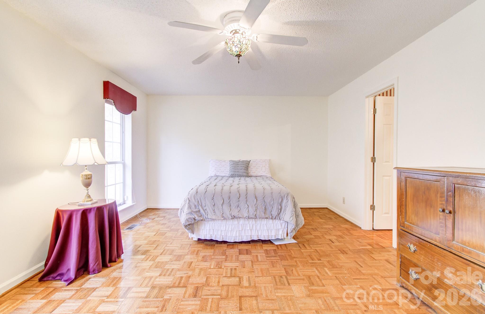 456 Mills Gap Road Arden, NC 28704 - Photo 15 of 43 a bedroom with a bed and a dresser