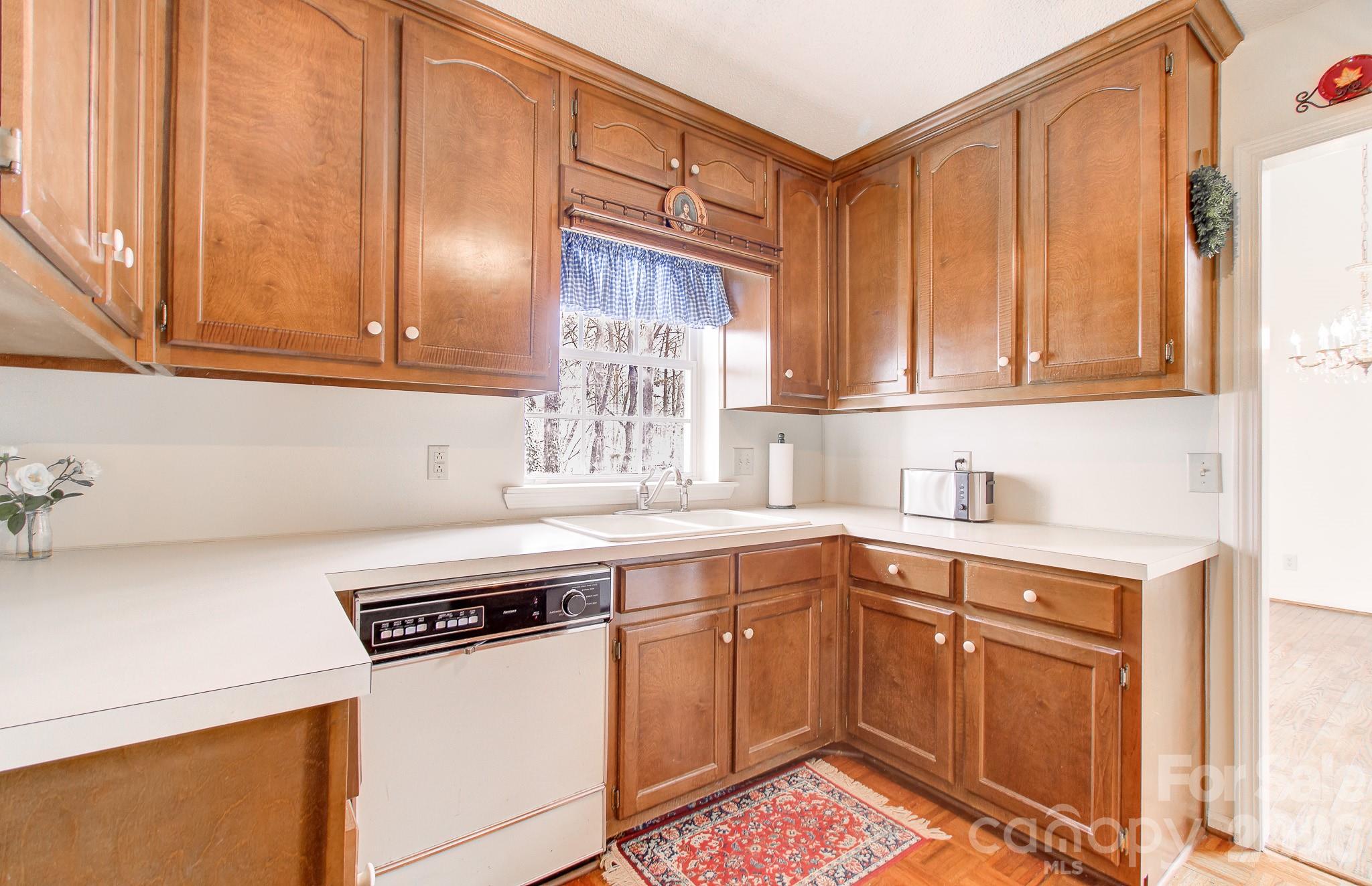 456 Mills Gap Road Arden, NC 28704 - Photo 30 of 43 a kitchen with stainless steel appliances granite countertop a sink stove and cabinets