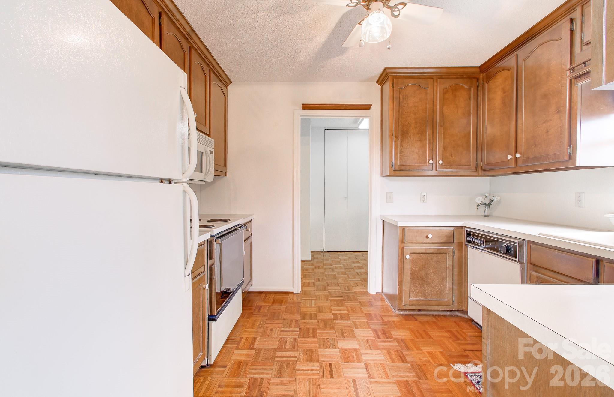 456 Mills Gap Road Arden, NC 28704 - Photo 31 of 43 a kitchen with granite countertop a refrigerator and a stove top oven