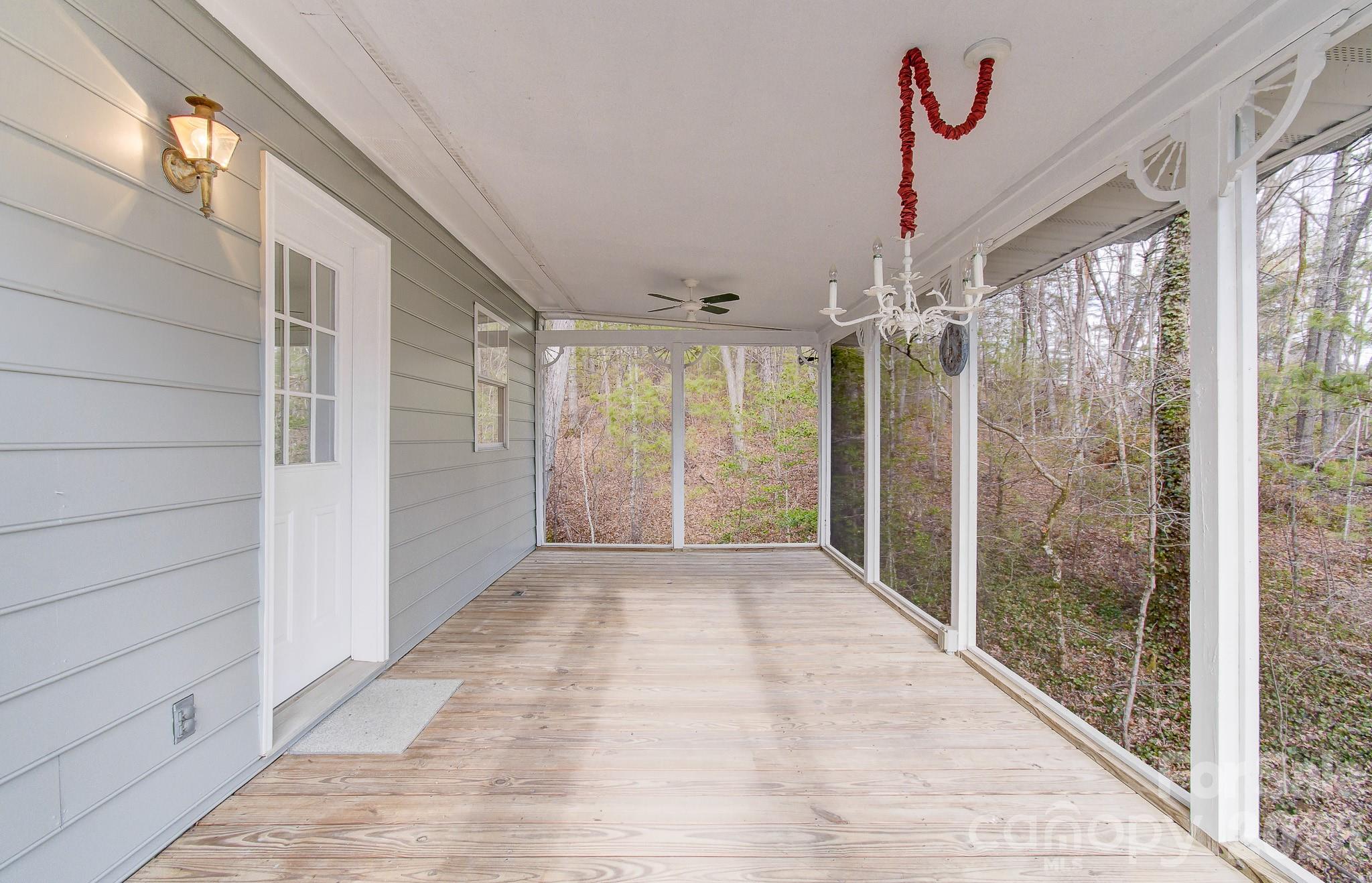 456 Mills Gap Road Arden, NC 28704 - Photo 38 of 43 a view of hallway with chandelier and glass door