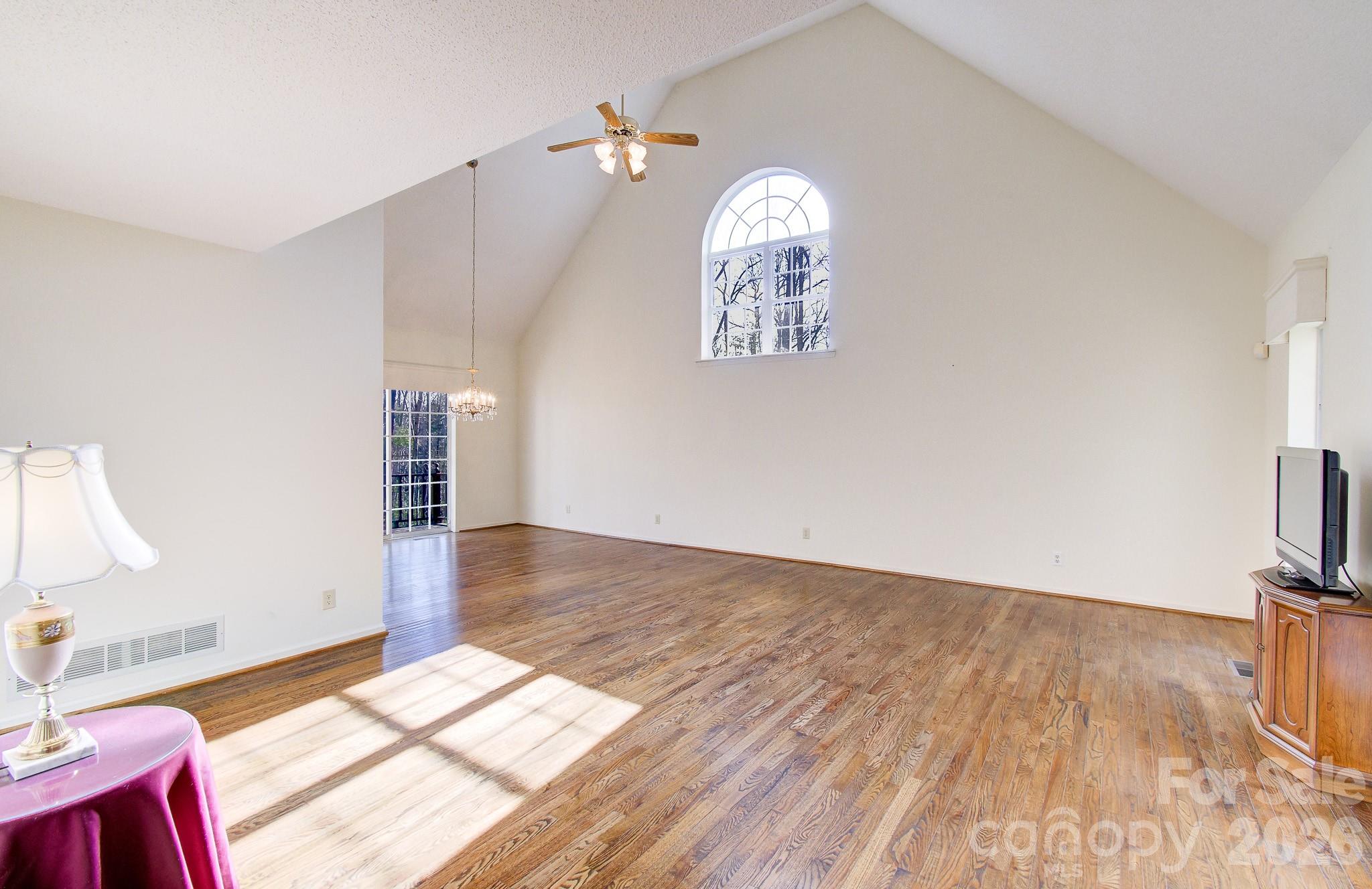 456 Mills Gap Road Arden, NC 28704 - Photo 7 of 43 a view of a livingroom with wooden floor and a kitchen space