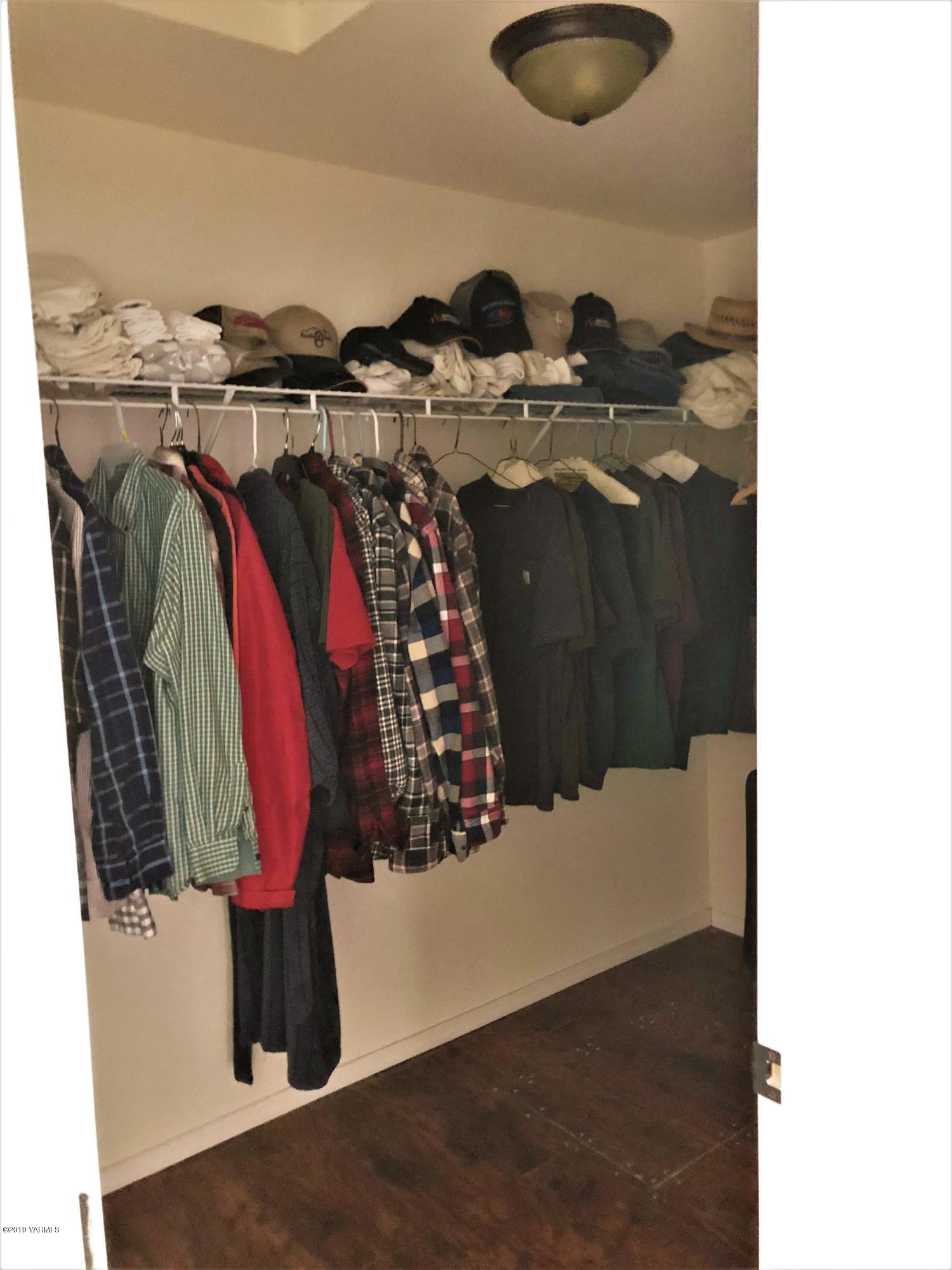 400 Bagley Road Granger, WA 98932 - Photo 22 of 28 a view of walk in closet with clothes and shoes