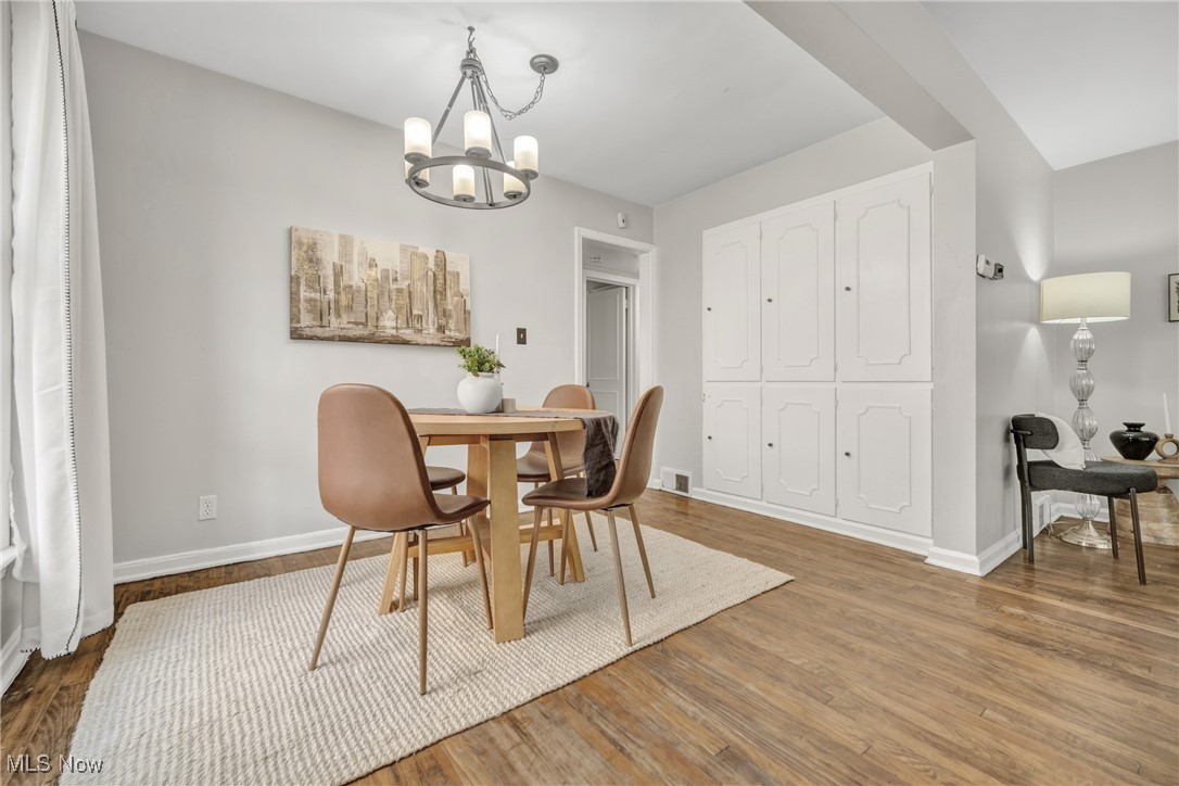 2440 White Road Cleveland, OH 44118 - Photo 13 of 43 Dining area featuring hardwood / wood-style floors and an inviting chandelier