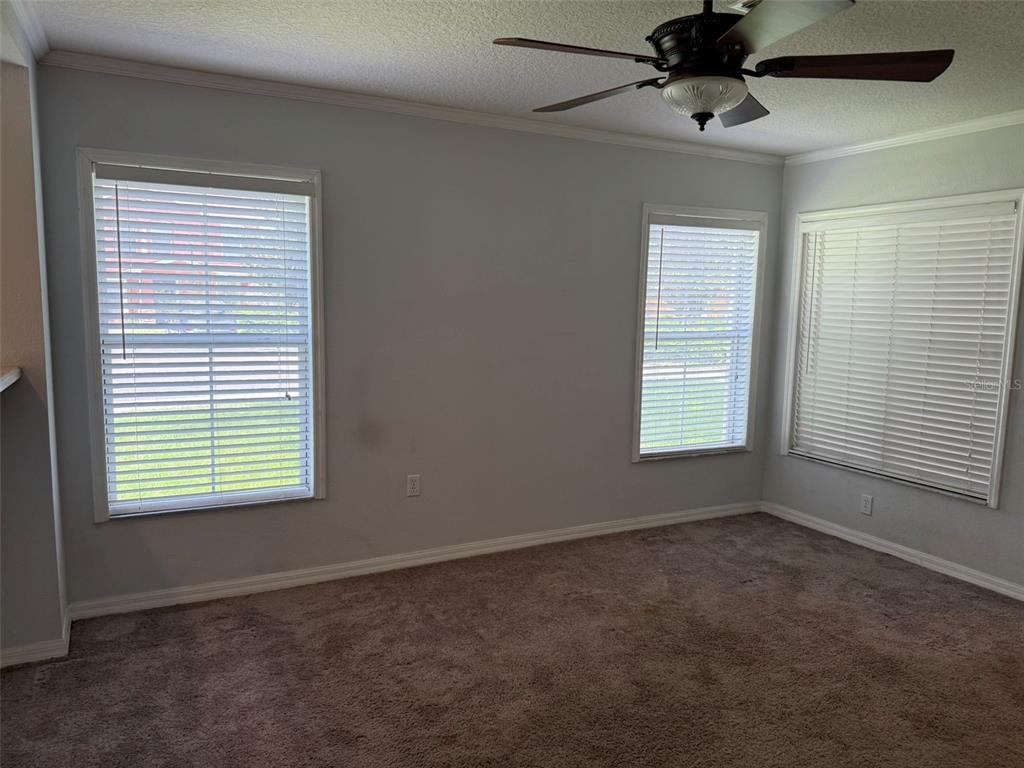 6907 Marble Fawn Place Riverview, FL 33578 - Photo 4 of 11 an empty room with a window and a fan