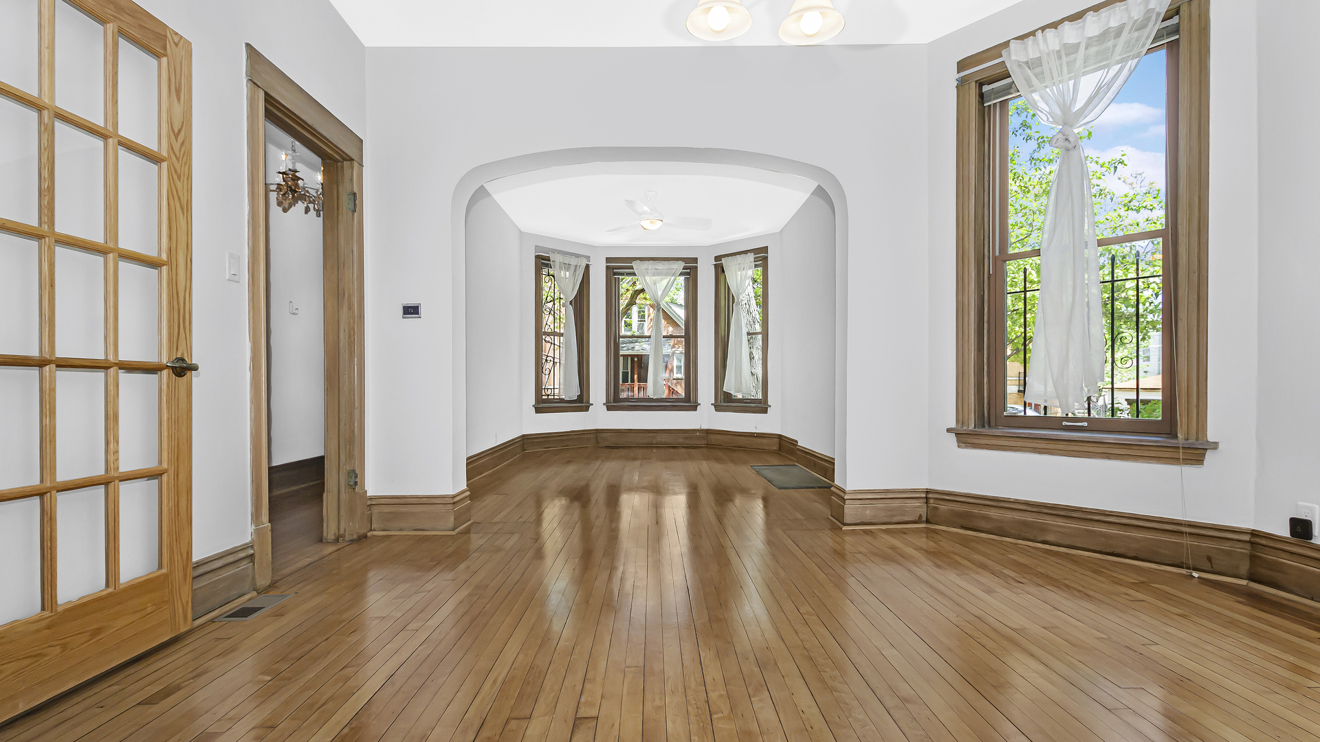2619 West Rice Street Chicago, IL 60622 - Photo 49 of 65 a view of a livingroom with wooden floor and a window