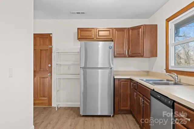 a utility room with wooden floor and electronic appliances