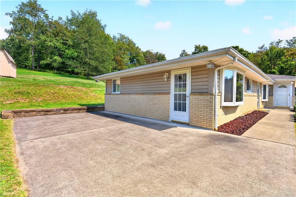 312 Gringo Independence Road, Unit R Aliquippa, PA 15001 - Photo 34 of 49 The expansive patio provides the perfect setting to relax, entertain, and enjoy the serene views.