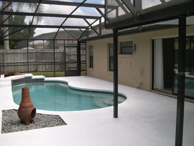 a view of a swimming pool with a yard