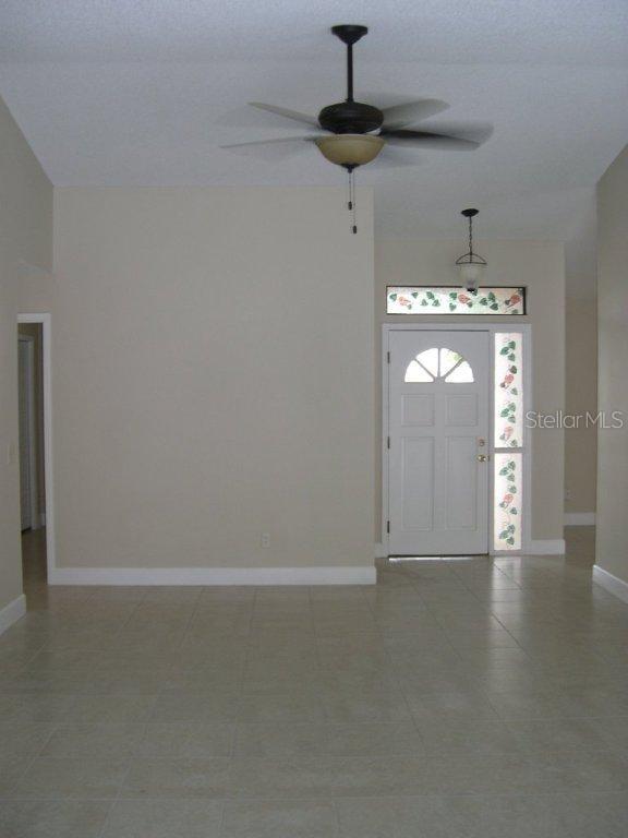1437 East Amanda Road Kissimmee, FL 34744 - Photo 2 of 12 a view of empty room with windows and ceiling fan