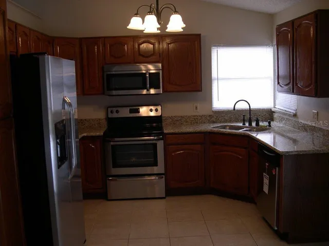 a kitchen with a sink stove and refrigerator