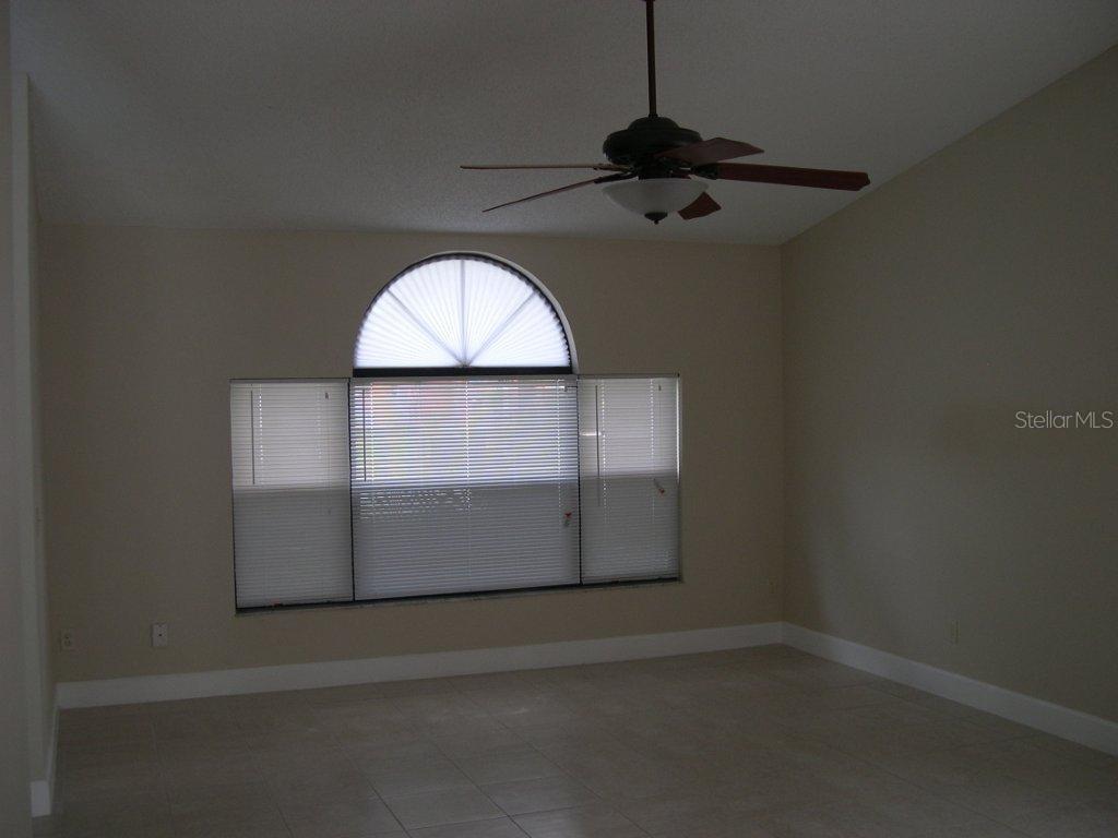 1437 East Amanda Road Kissimmee, FL 34744 - Photo 8 of 12 an empty room with a window