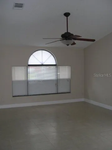 a view of a livingroom with a ceiling fan and window