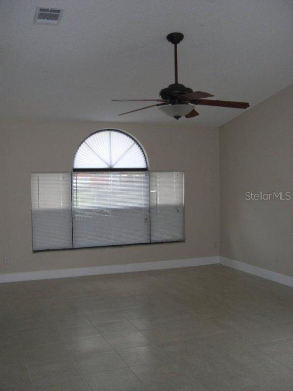 1437 East Amanda Road Kissimmee, FL 34744 - Photo 9 of 12 a view of a livingroom with a ceiling fan and window