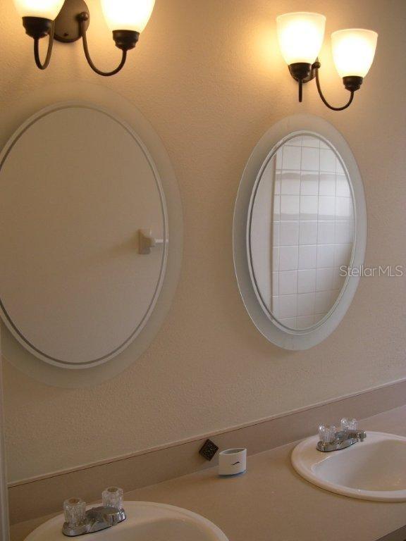 1437 East Amanda Road Kissimmee, FL 34744 - Photo 10 of 12 a bathroom with a sink and a mirror