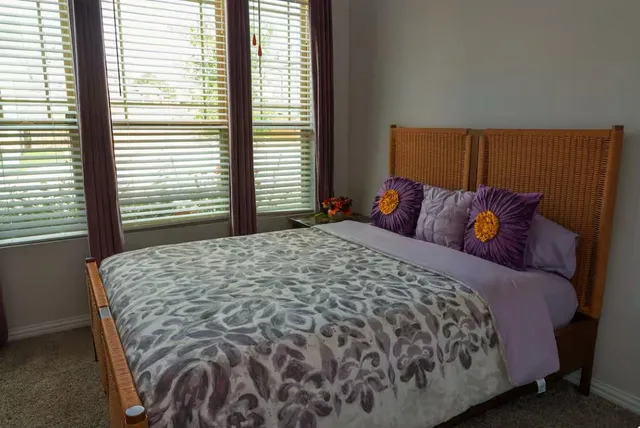 a bedroom with a bed and window