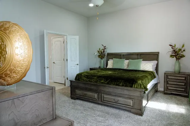 a bedroom with a bed and a chandelier