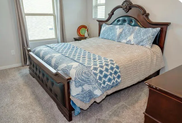 a bedroom with a bed and window