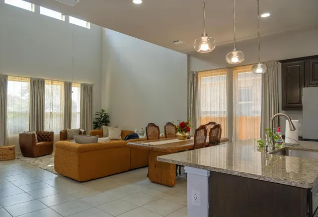 a reception area with glass top table and sofas