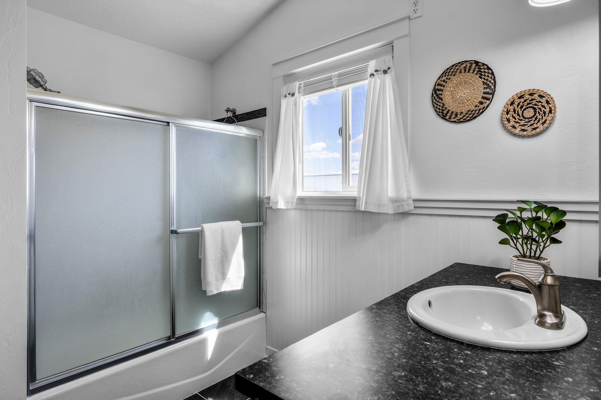 61600 Ward Road Bend, OR 97702 - Photo 27 of 52 a bathroom with a sink a mirror and shower