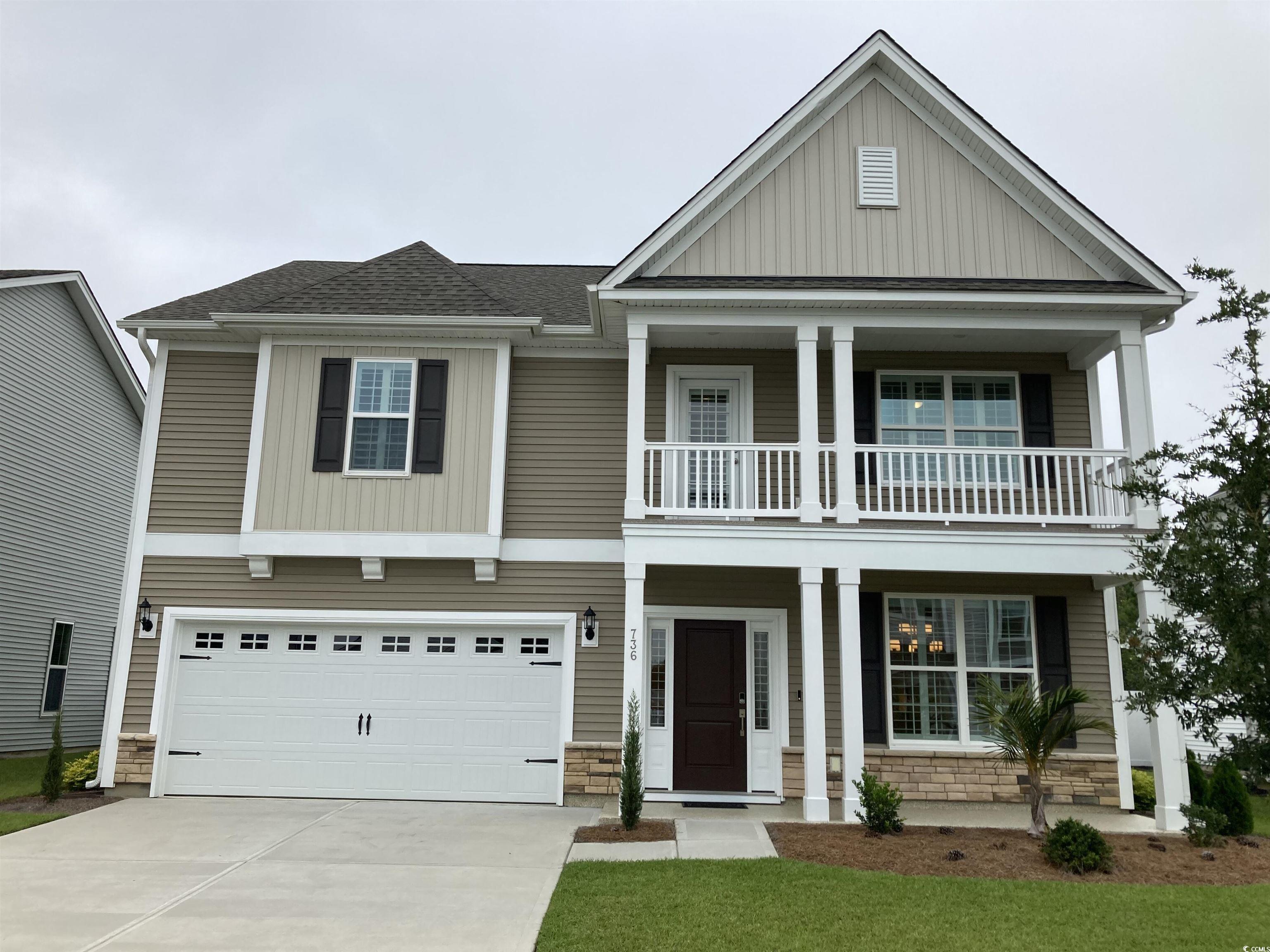 736 Enchantment Loop Myrtle Beach, SC 29588 - Photo 1 of 39 View of front of property with a porch, board and batten siding, stone siding, and an attached garage