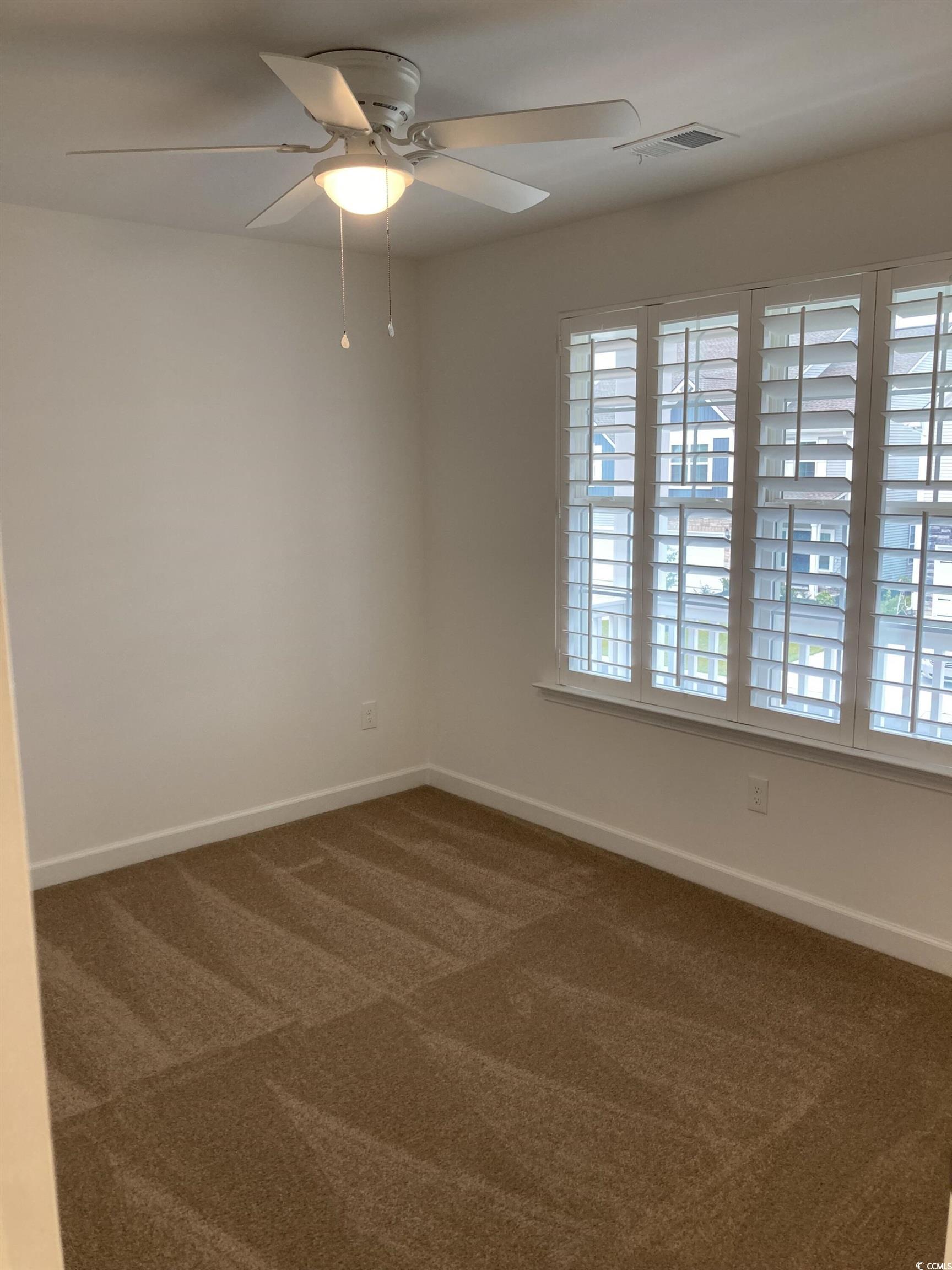 736 Enchantment Loop Myrtle Beach, SC 29588 - Photo 29 of 39 Empty room with dark carpet and ceiling fan