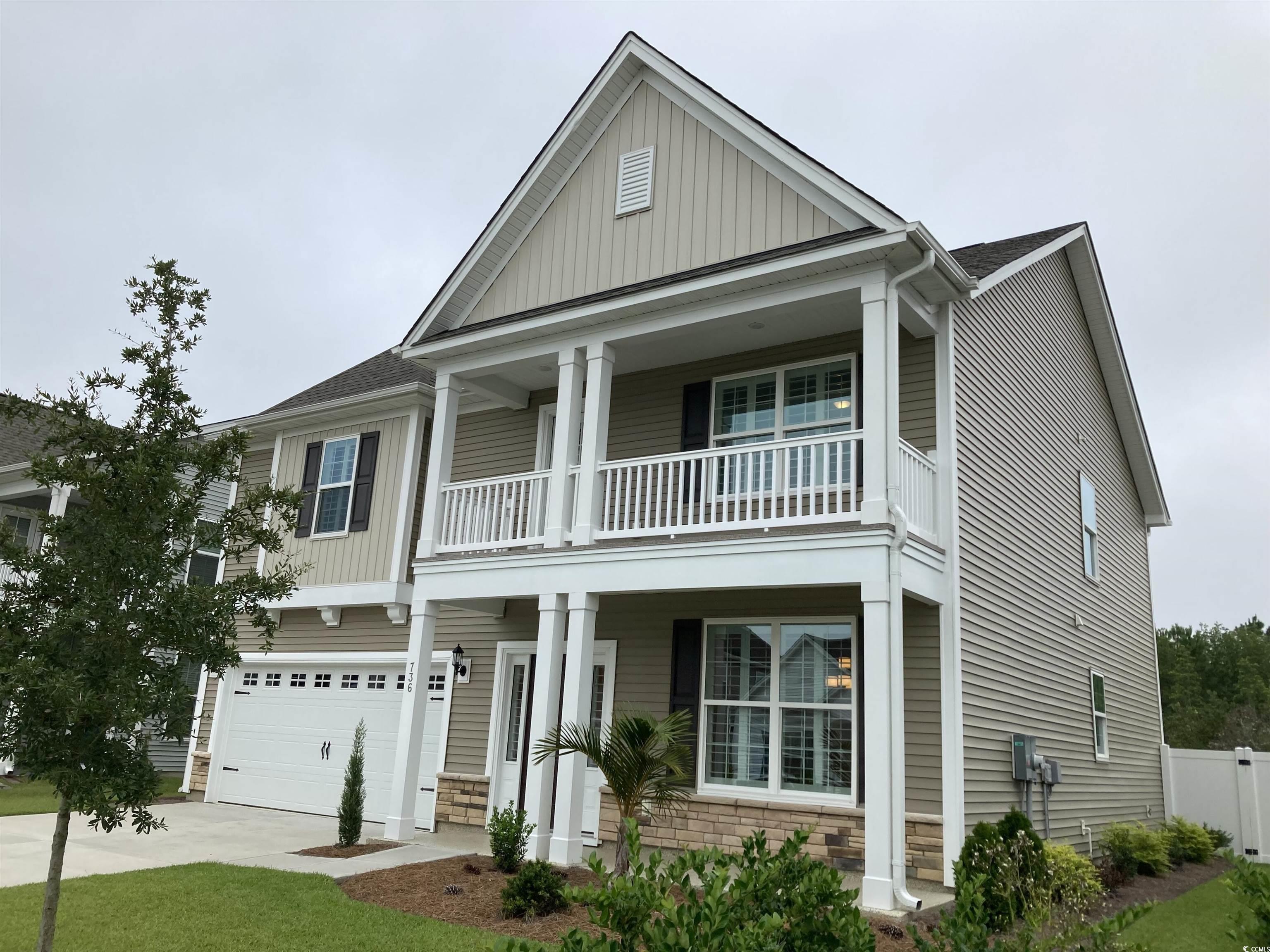 736 Enchantment Loop Myrtle Beach, SC 29588 - Photo 3 of 39 View of front facade featuring covered porch, driveway, stone siding, and board and batten siding