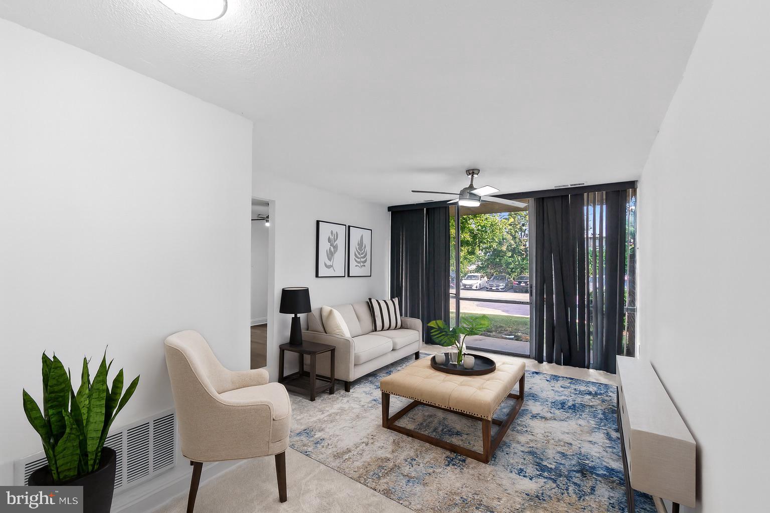7975 Riggs Road, Unit 4 Hyattsville, MD 20783 - Photo 1 of 22 a living room with furniture and a large window