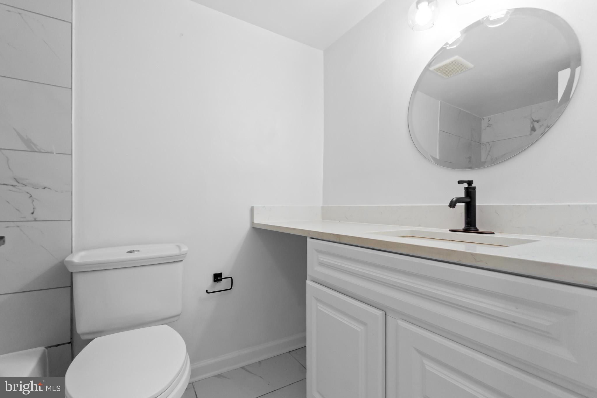 7975 Riggs Road, Unit 4 Hyattsville, MD 20783 - Photo 13 of 22 a bathroom with a toilet a sink and mirror