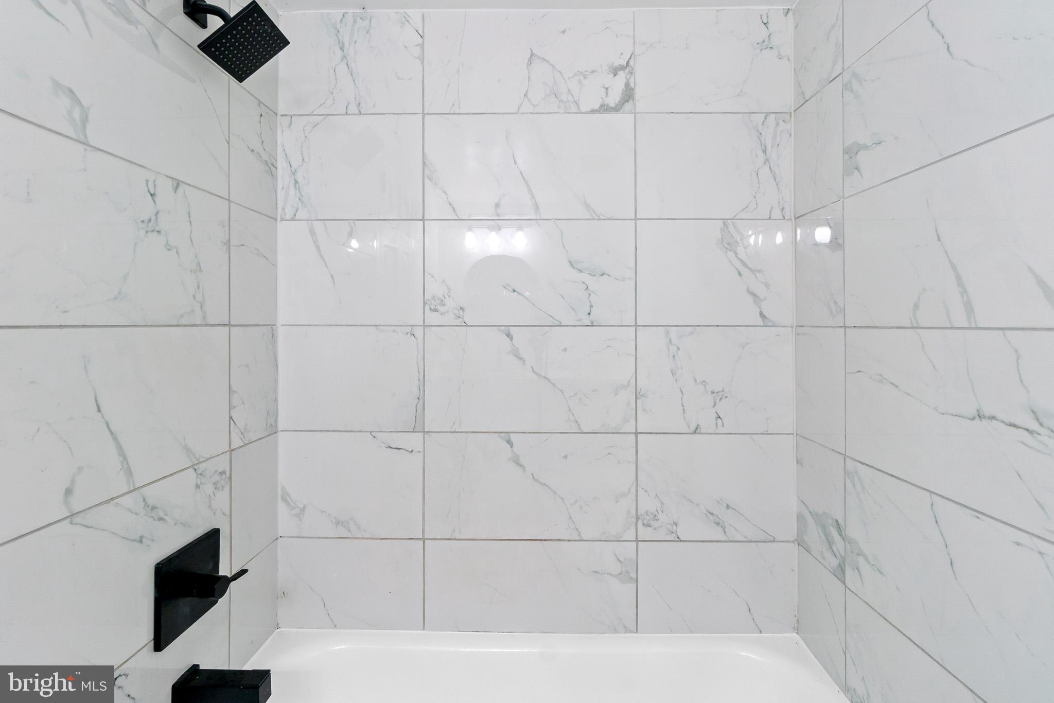 7975 Riggs Road, Unit 4 Hyattsville, MD 20783 - Photo 14 of 22 a bathroom with a bathtub and shower