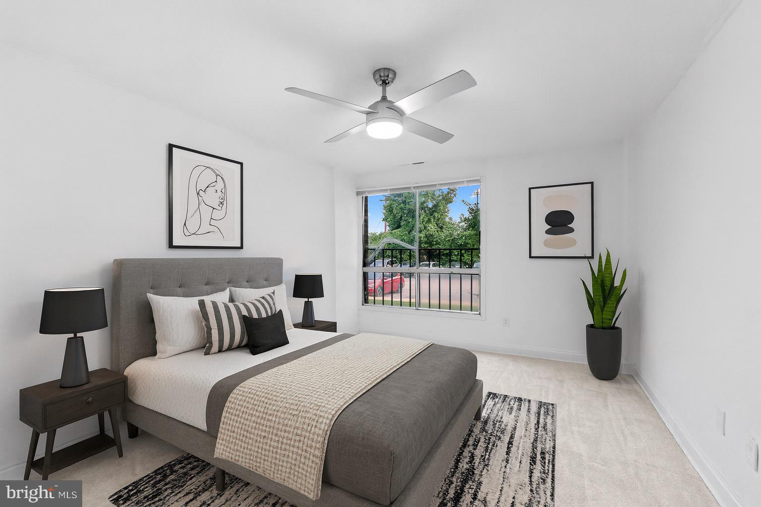 7975 Riggs Road, Unit 4 Hyattsville, MD 20783 - Photo 16 of 22 a bedroom with a large bed and a chandelier