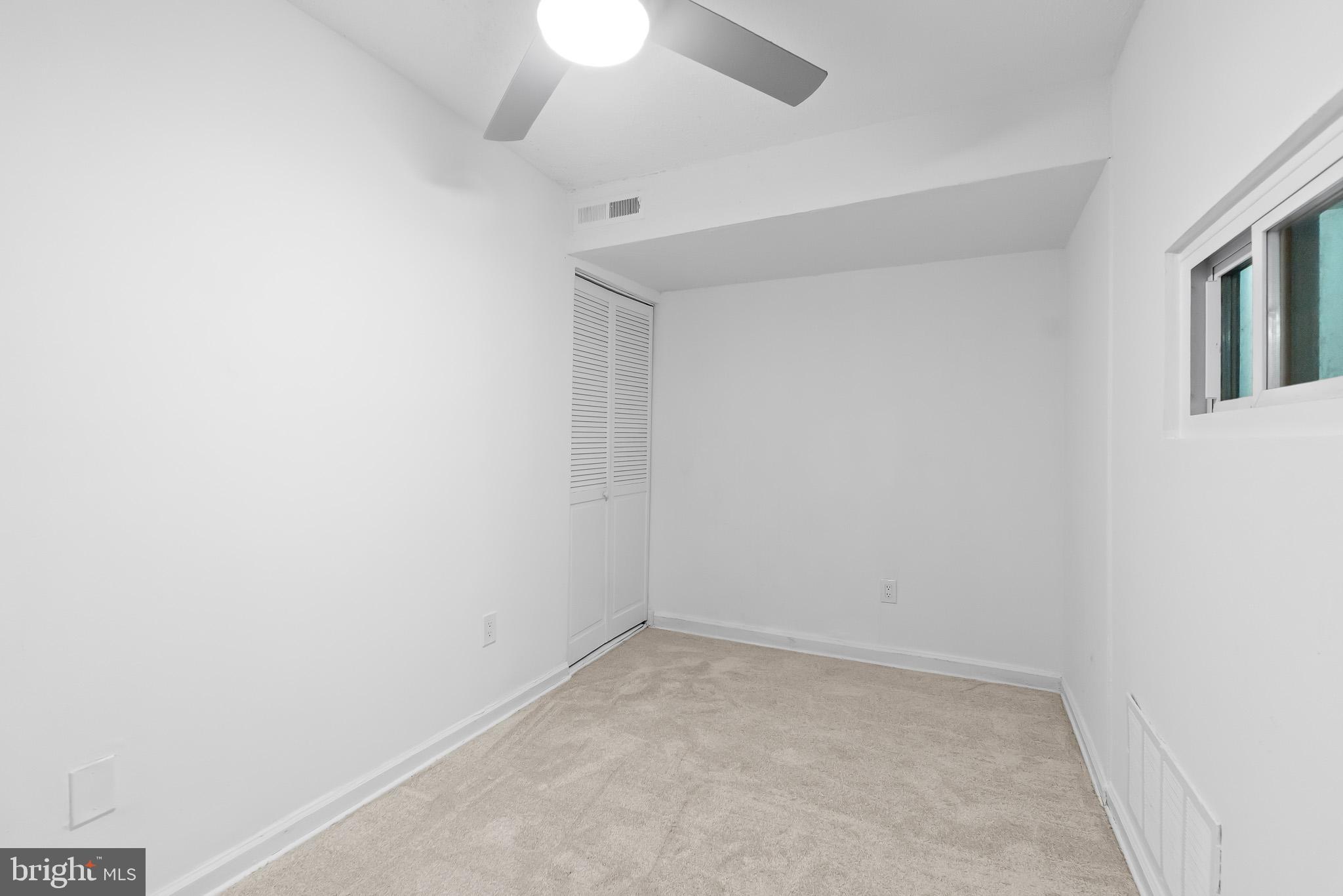 7975 Riggs Road, Unit 4 Hyattsville, MD 20783 - Photo 20 of 22 an empty room with a ceiling fan and window
