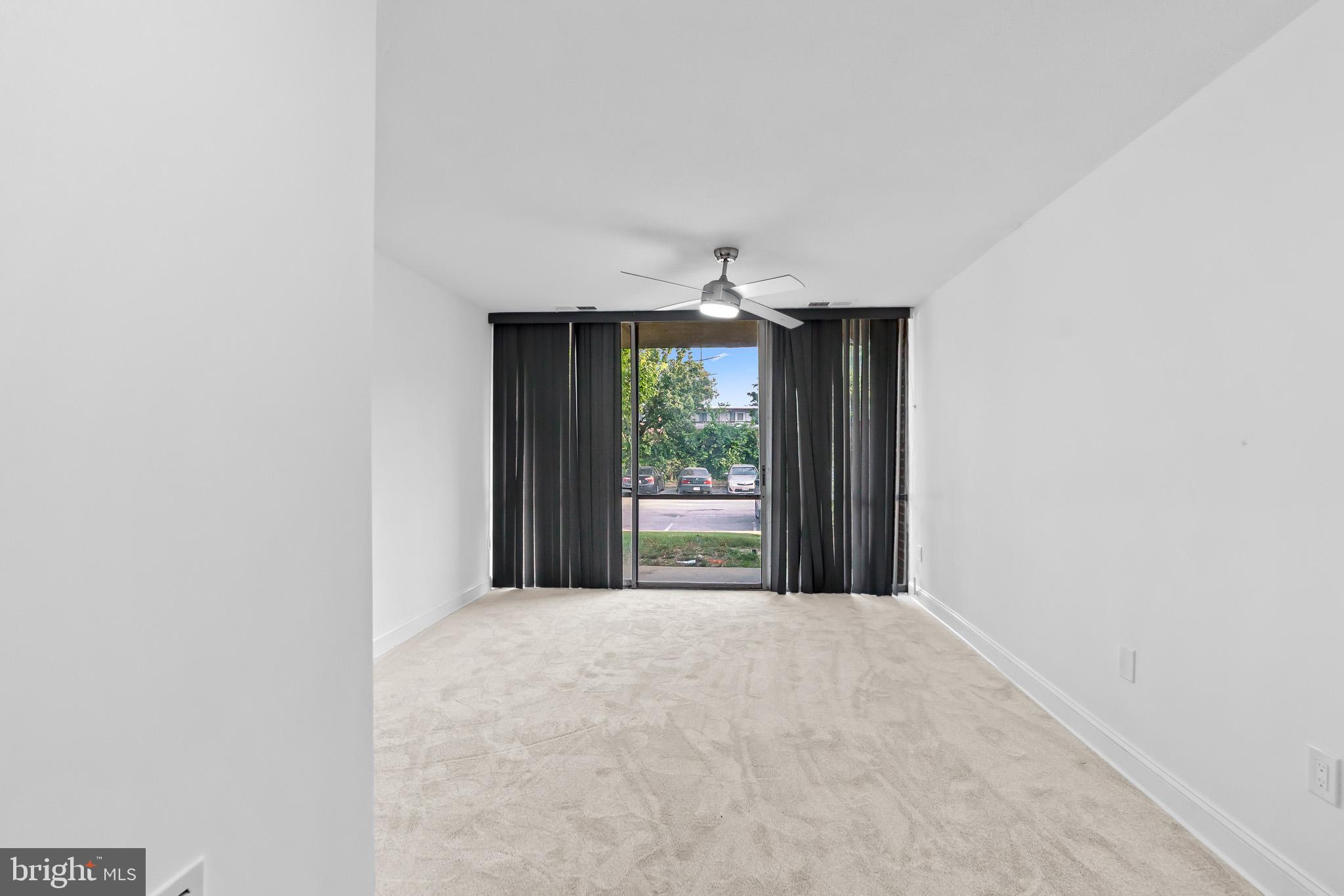 7975 Riggs Road, Unit 4 Hyattsville, MD 20783 - Photo 5 of 22 a view of a big room with yard and large window