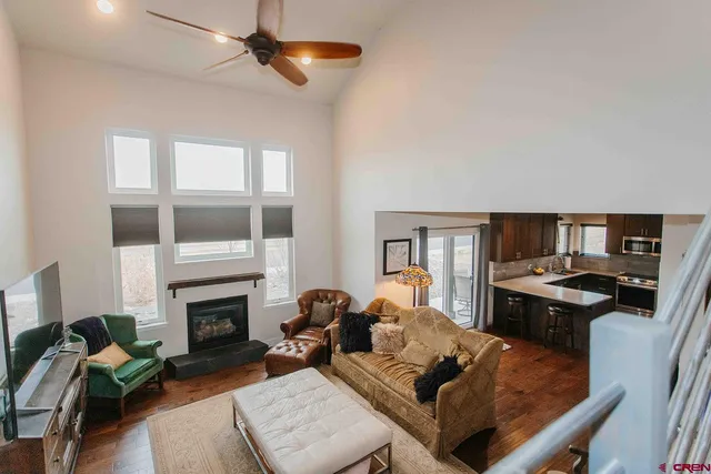 a living room with furniture fireplace and a window