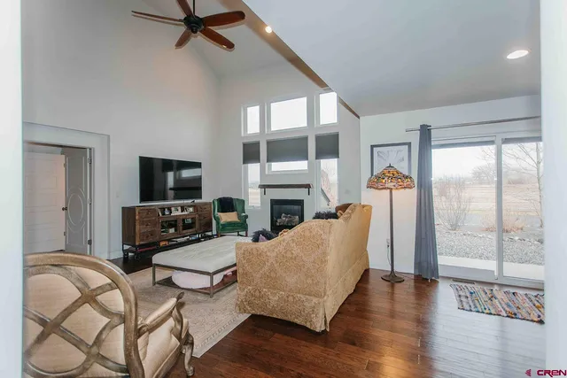 a living room with furniture a flat screen tv and a fireplace